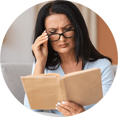 Woman with glasses reading a book